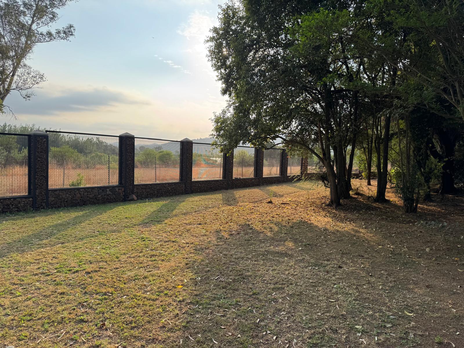 Stacked-stone fence pillars at Ballyteran in golden-hour light, distant landscape behind