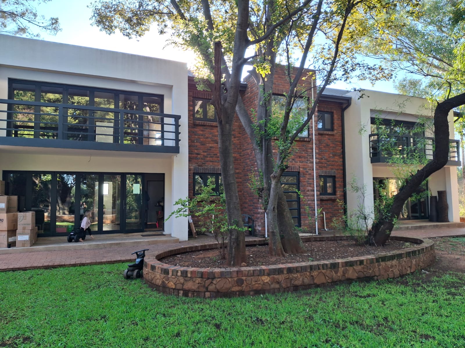 Two of the four Ballyteran units, brick and render, set among mature trees